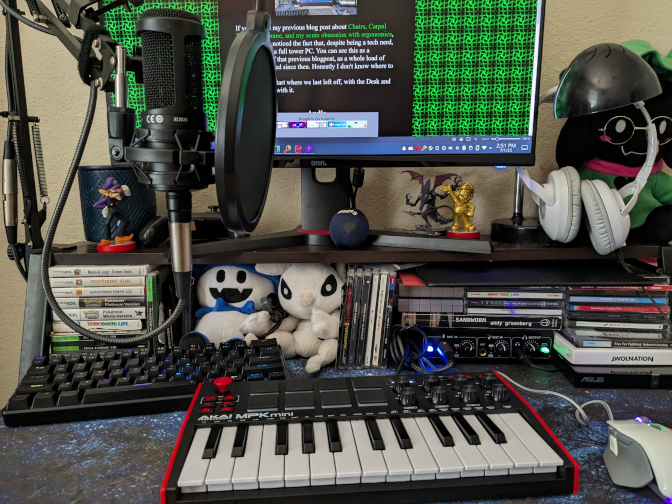 A picture of my desk, with a bunch of audio equipment like a microphone, midi keyboard, and an audio interface